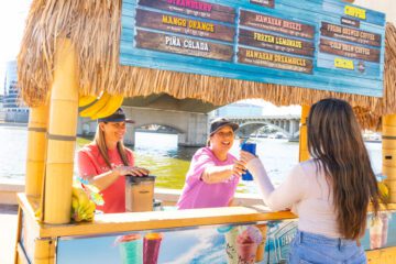 Maui Wowi employee handing customer a smoothie